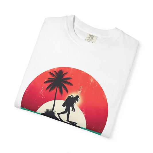 white comfort colors t-shirt with a scuba diver walking on an island at sunset.