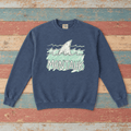 Montauk shark sweatshirt front in Denim with sea-green waves on colorful weathered driftwood boards