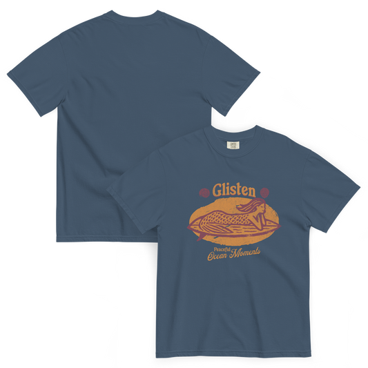 Blue short sleeve t-shirt with the words glisten on it and a mermaid laying on a surf board