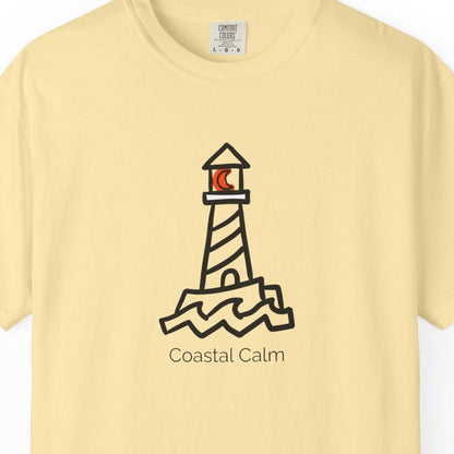 Yellow t-shirt with a lighthouse design and 'Coastal Calm' text on a white background