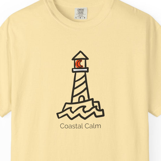 Yellow t-shirt with a lighthouse design and 'Coastal Calm' text on a white background