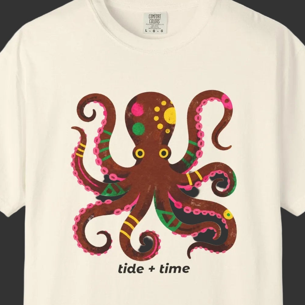 Beige t-shirt with a colorful octopus design and 'tide + time' text on a white background