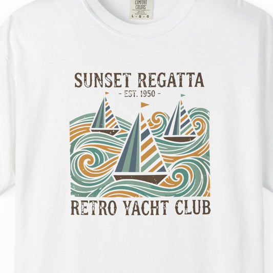 White t-shirt with 'Sunset Regatta' graphic design on a white background
