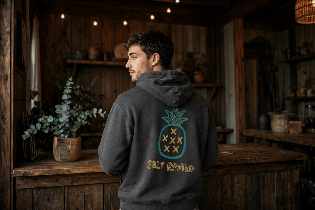 Salt Rooted Pineapple Hoodie — in the Five Tides room, male back
