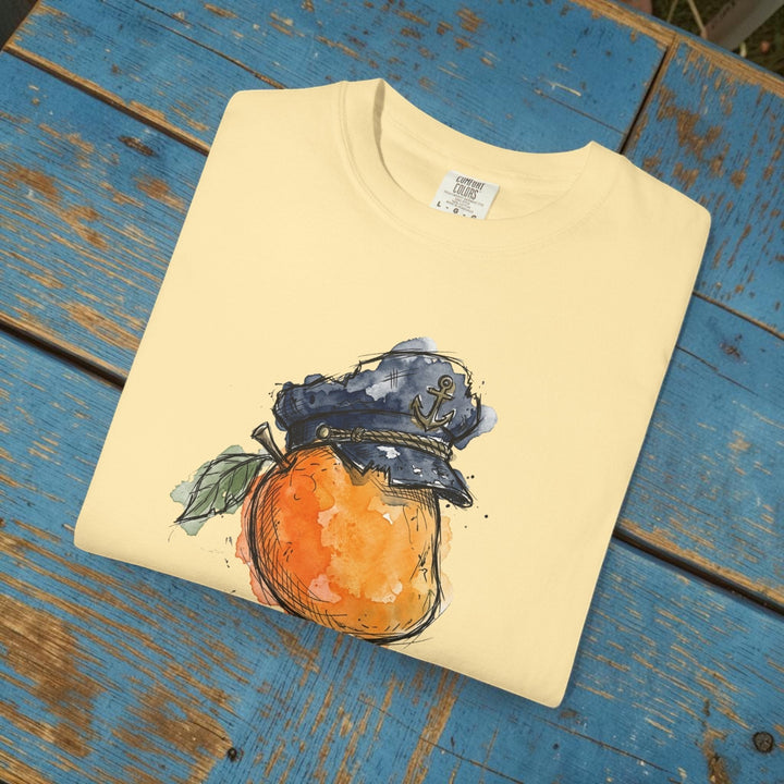 Folded yellow t-shirt with a graphic of an orange wearing a captain&