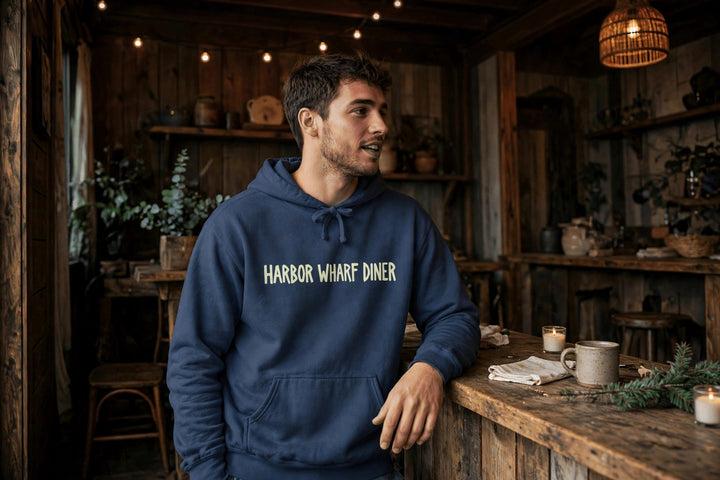 Harbor Wharf Diner Hoodie — in the Five Tides room, male front