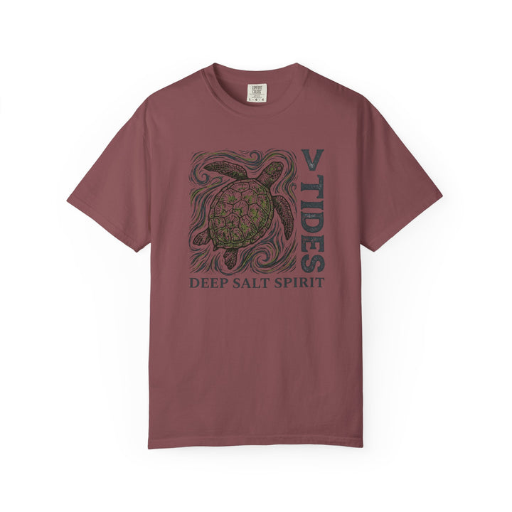 Maroon t-shirt with turtle graphic and text on a white background