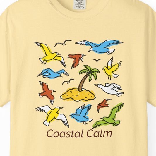 Yellow t-shirt with colorful coastal-themed design on a white background