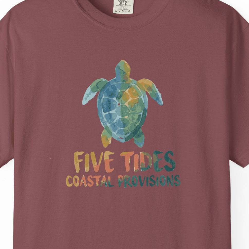 Maroon t-shirt with a turtle graphic and text on a white background