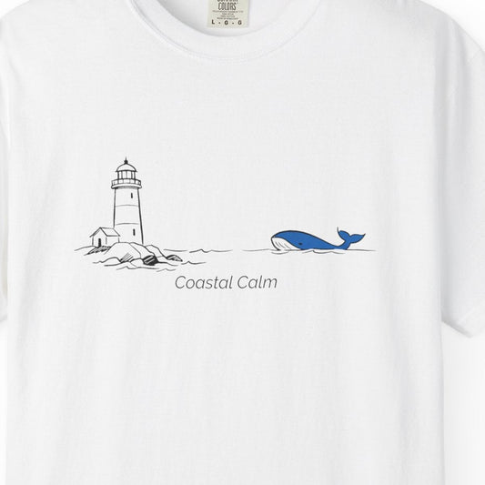 White t-shirt with a lighthouse and whale design on a white background