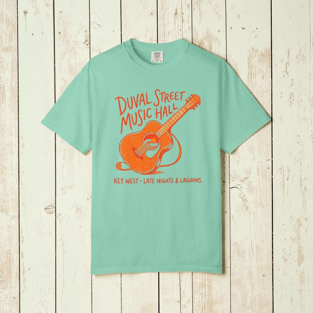 Mint green t-shirt with orange guitar graphic and text on a white background