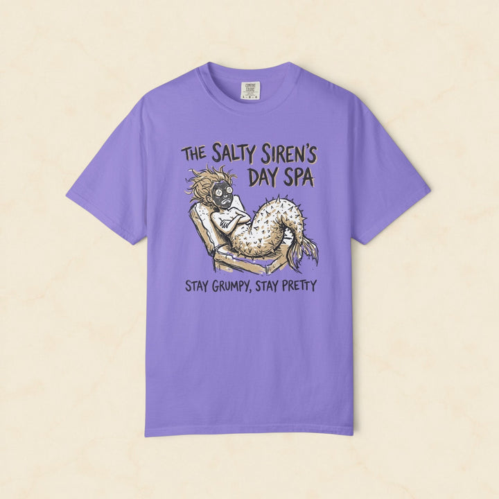 Purple t-shirt with a mermaid graphic and text on a white background