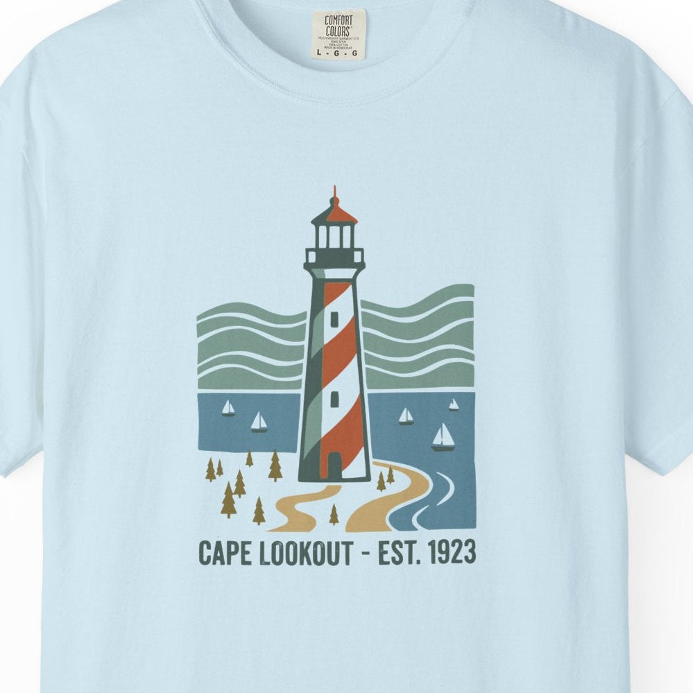 Light blue t-shirt with a lighthouse graphic on a white background