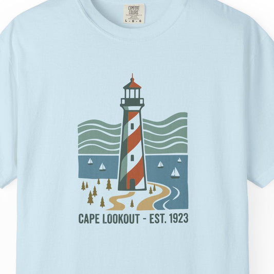 Light blue t-shirt with a lighthouse graphic on a white background