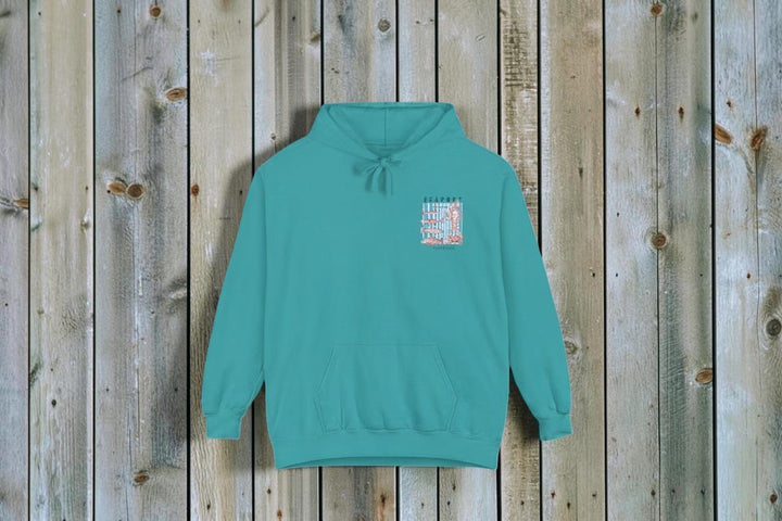 Teal hoodie with a small graphic on the chest against a white background