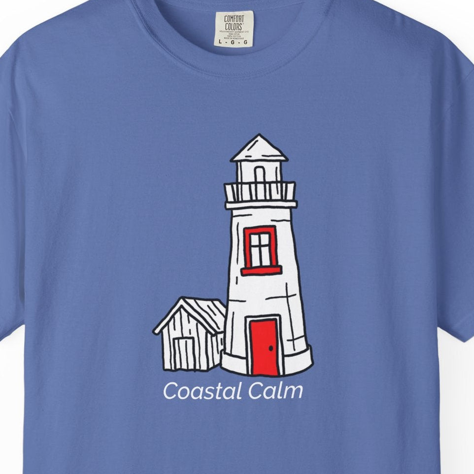 Blue t-shirt with a lighthouse graphic and 'Coastal Calm' text on a white background