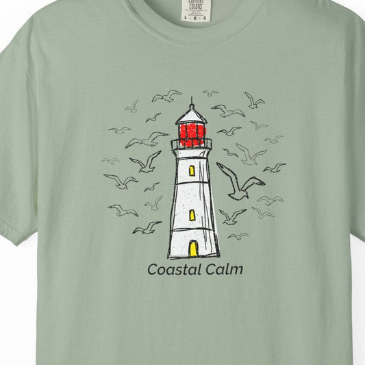 Light green t-shirt with a lighthouse design and 'Coastal Calm' text on a white background
