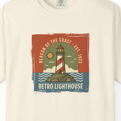Beige t-shirt with retro lighthouse graphic on a white background