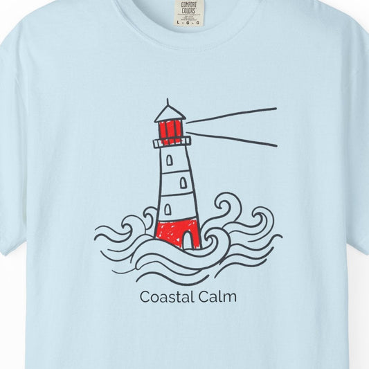 Light blue t-shirt with a lighthouse design and 'Coastal Calm' text on a white background