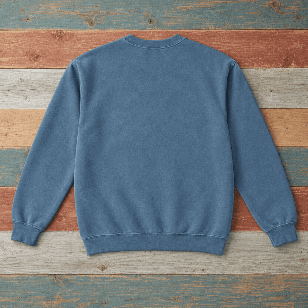 Plain back of Bar Harbor crewneck sweatshirt in Blue Jean on colorful weathered driftwood boards