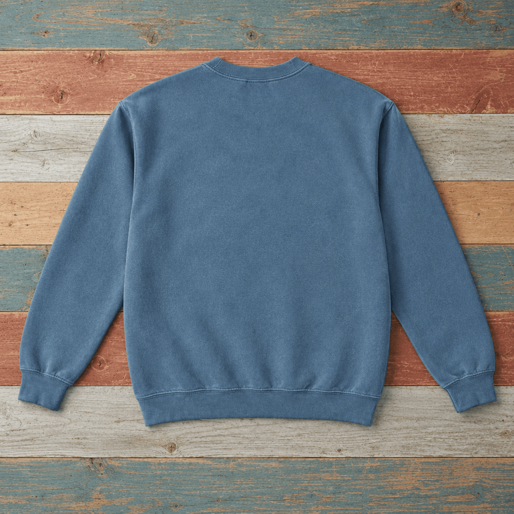 Plain back of Bar Harbor crewneck sweatshirt in Blue Jean on colorful weathered driftwood boards