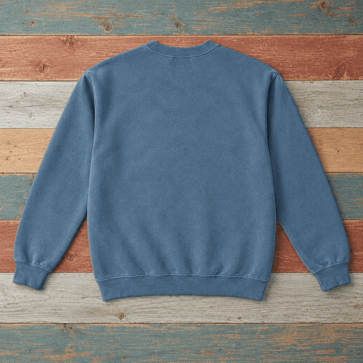 Plain back of Bar Harbor crewneck sweatshirt in Blue Jean on colorful weathered driftwood boards