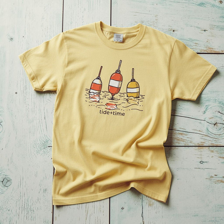 Tide + Time Beach Buoy banana garment-dyed tee casually tousled on rustic reclaimed wood