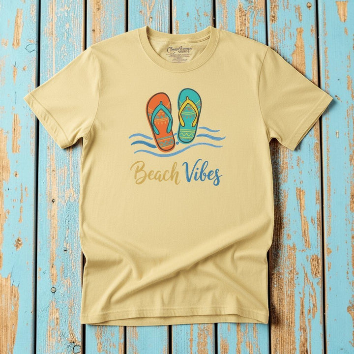 Flat lay - butter yellow Beach Vibes tee with Comfort Colors label on weathered driftwood planks