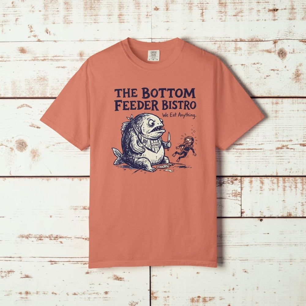 Coral t-shirt with a graphic design and text 'The Bottom Feeder Bistro' on a white background
