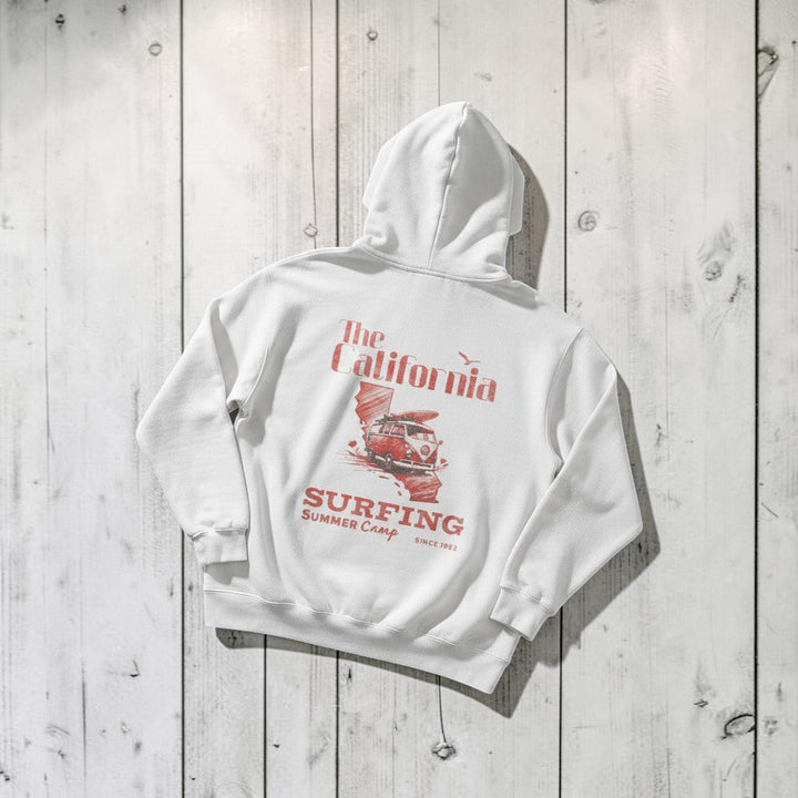 California Surfing Summer Camp Hoodie in White — back graphic, warm sand studio background