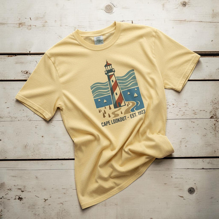 Cape Lookout Lighthouse banana garment-dyed tee on weathered wood planks