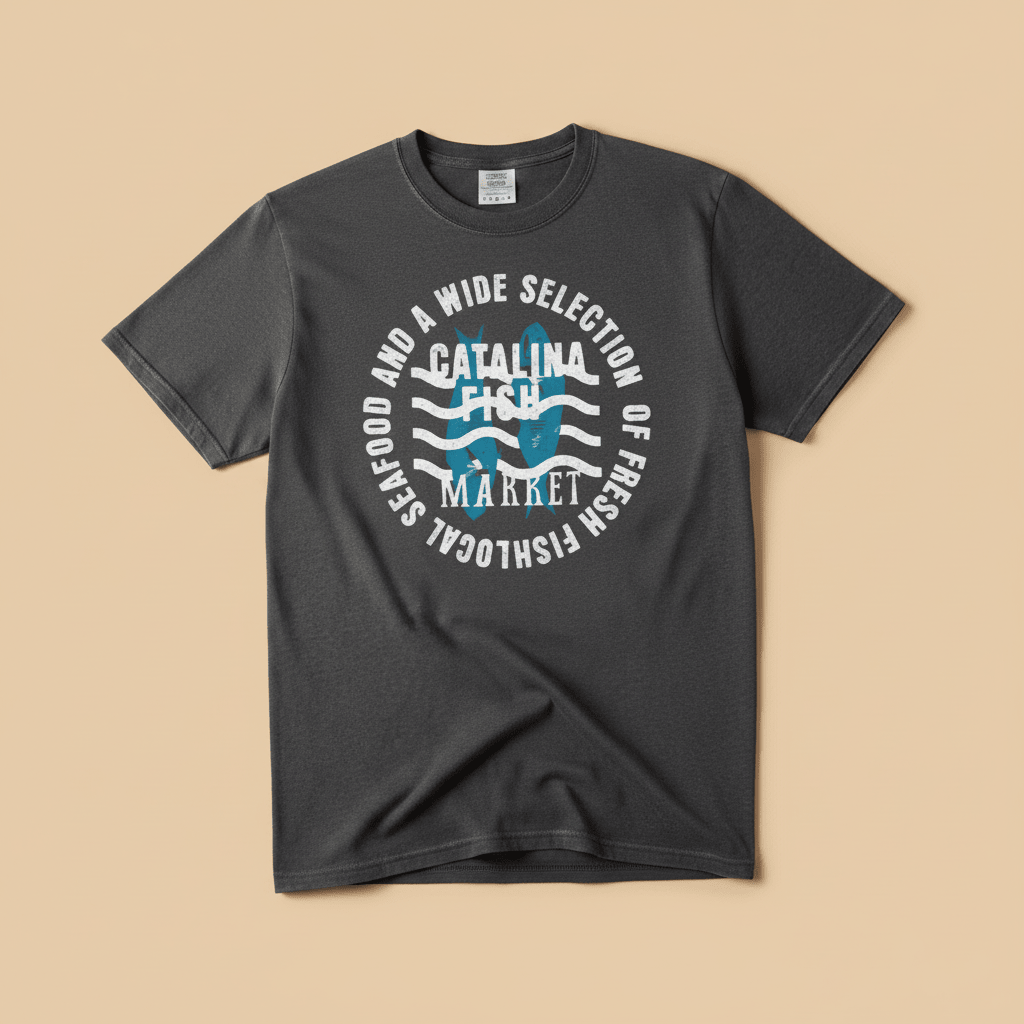 Catalina Fish Market Tee in Pepper/Charcoal — front graphic, warm sand studio background