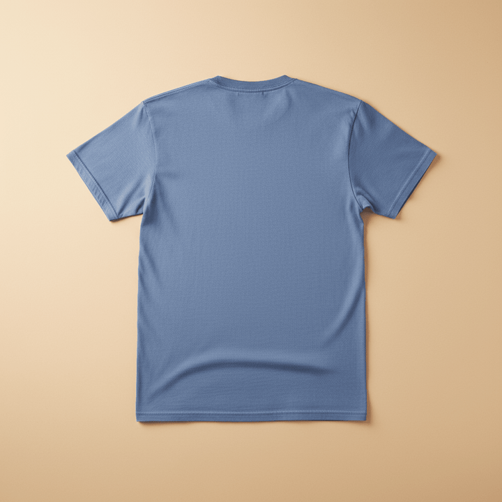 Catch the Thrill Tee in Washed Denim — plain back, warm sand studio background