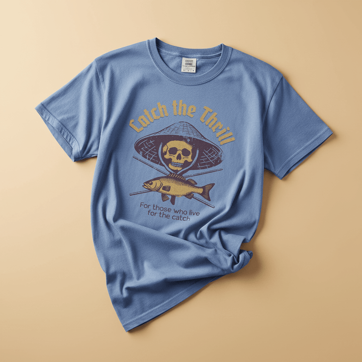 Catch the Thrill Tee in Washed Denim — front graphic, warm sand studio background