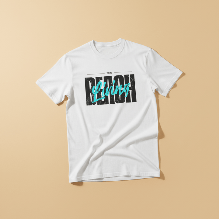 Beach Living Tee in White — front graphic, warm sand studio background