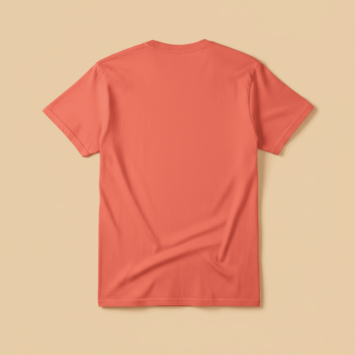 Beach Living Tee in Coral — plain back, warm sand studio background