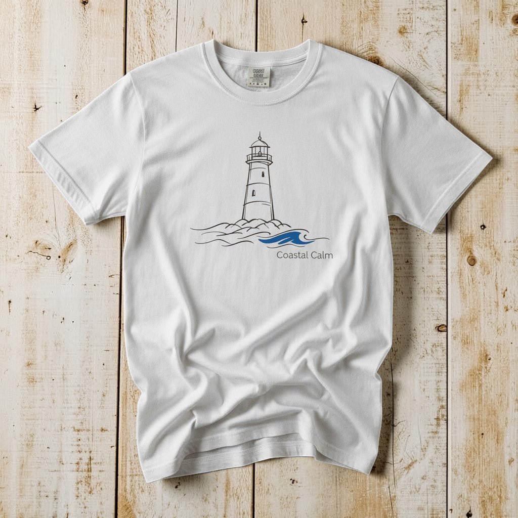 Coastal Calm Lighthouse Blue Sea white garment-dyed tee on faded driftwood planks