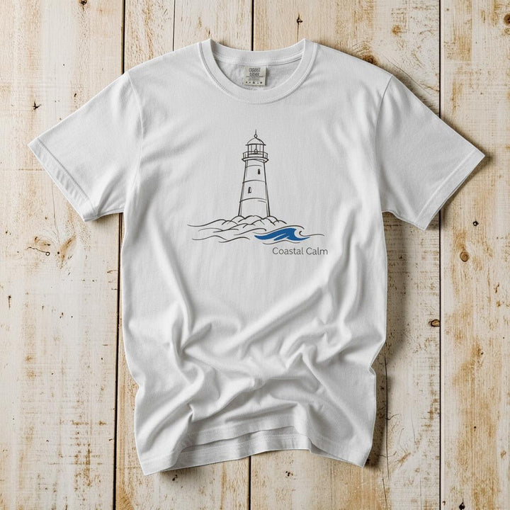 Coastal Calm Lighthouse Blue Sea white garment-dyed tee on faded driftwood planks