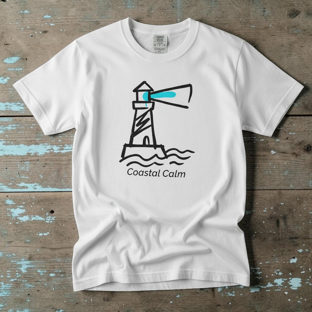 Coastal Calm Lighthouse white garment-dyed tee on faded driftwood planks