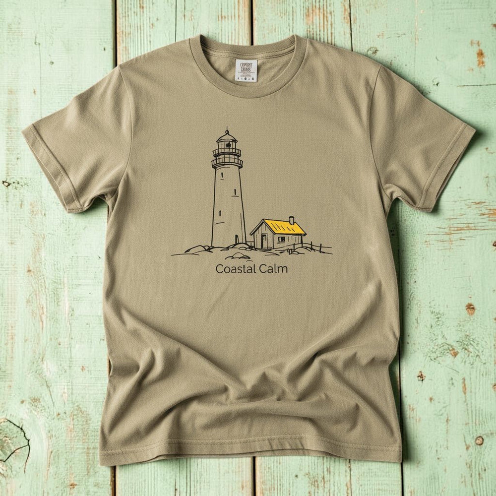 Coastal Calm Lighthouse Watch Hut khaki garment-dyed tee on faded driftwood planks