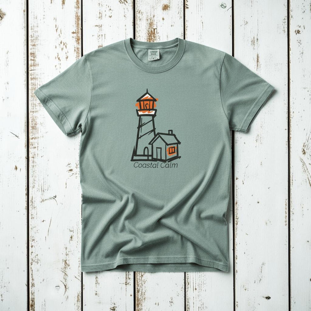 Coastal Calm Orange Lookout Lighthouse bay garment-dyed tee on faded driftwood planks