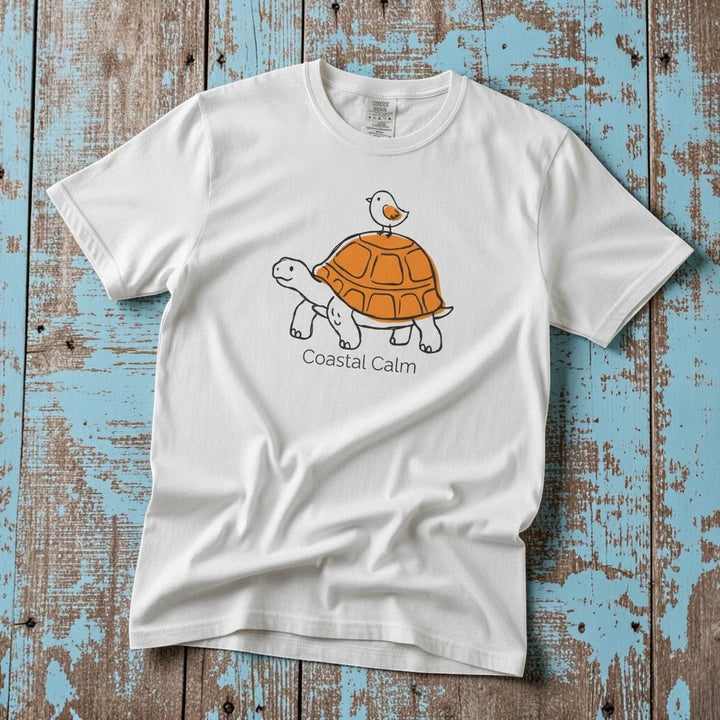 Coastal Calm Turtle Buddies II white garment-dyed tee on faded driftwood planks