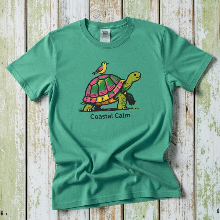 Coastal Calm Turtle Buddies island green garment-dyed tee on faded driftwood planks