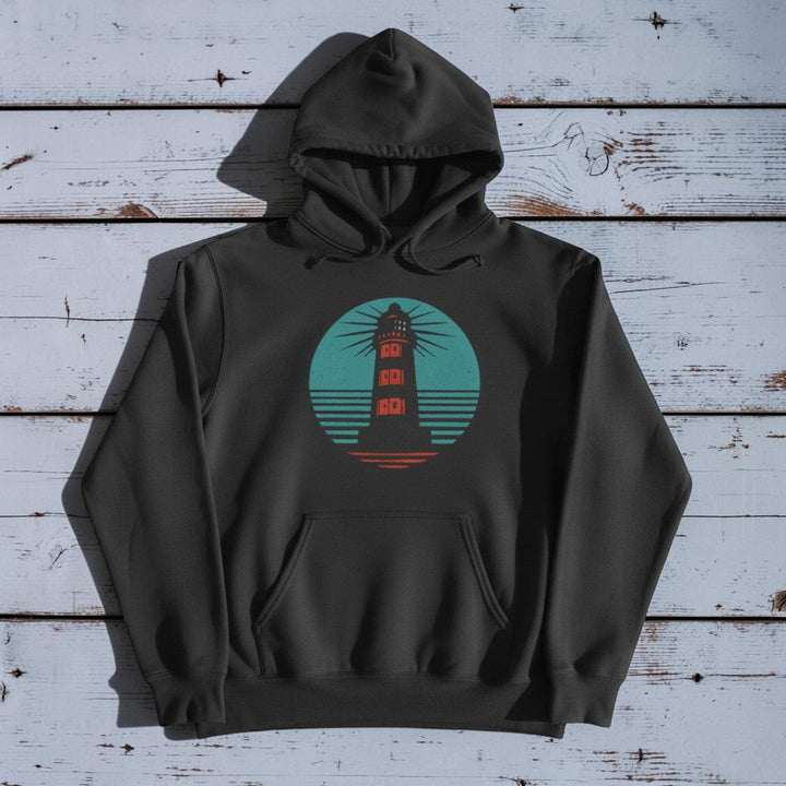 Coastal Lighthouse Hoodie in Pepper — front graphic, warm sand studio background