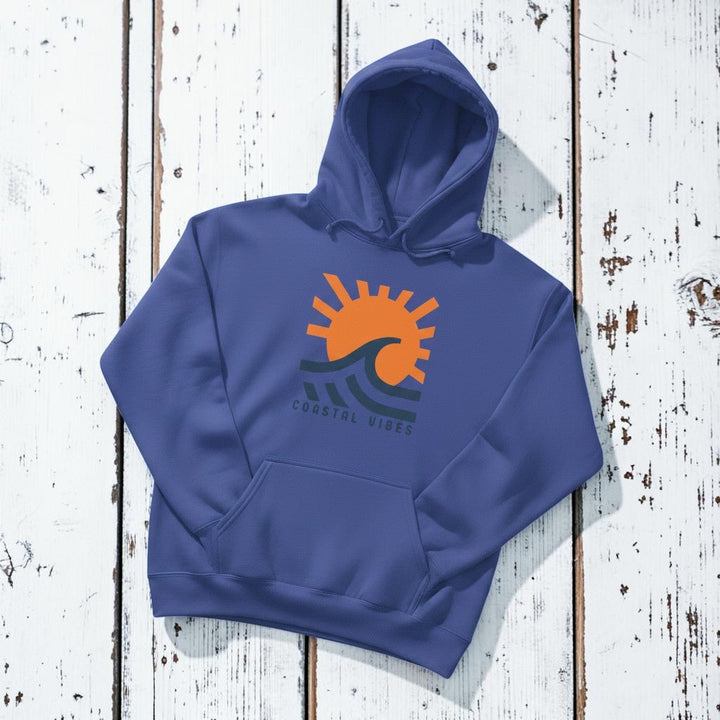 Coastal Vibes Hoodie in Flo Blue — front graphic, warm sand studio background