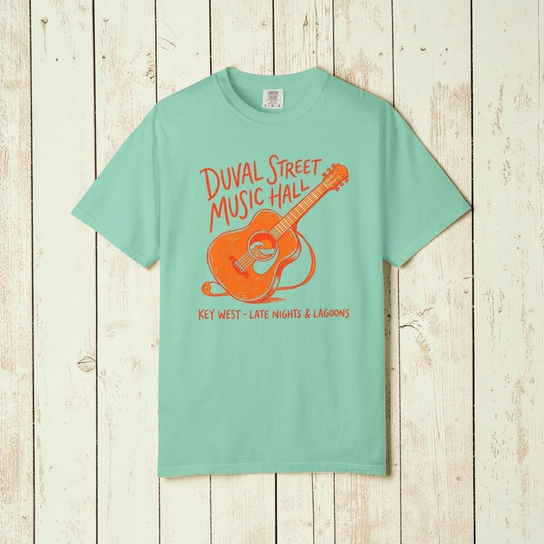 Mint green t-shirt with orange guitar graphic and text on a white background