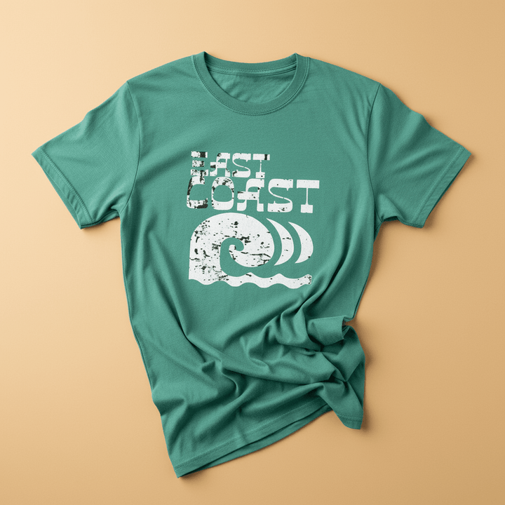 East Coast Tee in Island Green — front graphic, warm sand studio background