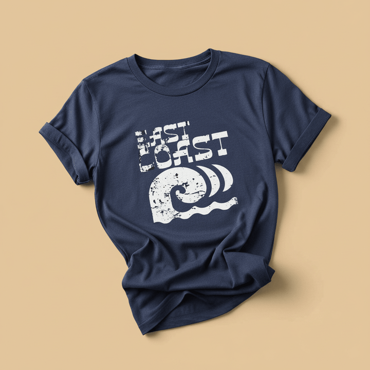 East Coast Tee in China Blue — front graphic, warm sand studio background