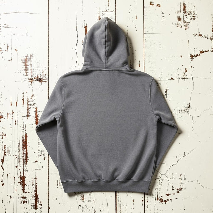 East Coast Hoodie in Medium Grey — plain back, warm sand studio background