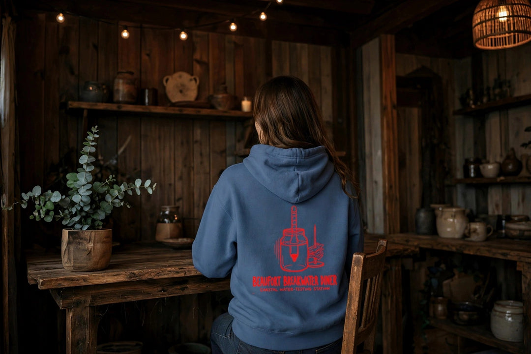 Beaufort Breakwater Diner Hoodie — in the Five Tides room, female back